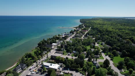 Drone-aerial-shot-revealing-downtown-main-street-in-bailey's-harbor,-Door-County