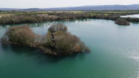 Aerial-orbit-above-storks-nest-in-reed-island-pond-of-ancient-Antela-lagoon-Areeiras-da-Limia-in-Xinzo-de-Limia-Ourense-Galicia-Spain
