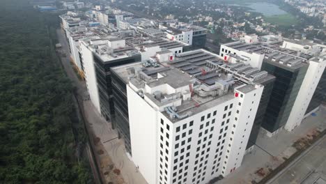 Corporate-Building-Near-A-Forest-With-Highway-Nearby-Passing-Cars