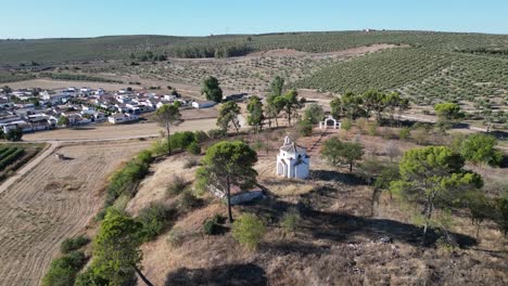 Aerial-of-La-Ermita-del-Poblado-de-San-Julián-,-a-historic-church-nestled-in-the-heart-of-Marmolejo,-exuding-centuries-of-cultural-and-religious-significance