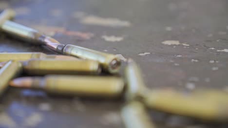Gun-Bullets-on-the-ground,-Passing-Rows-Of-M-16-Gun-Ammunition