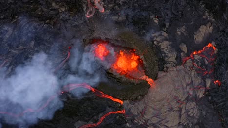 A-4K-drone-captures-slow-motion-aerial-cinematic-shots-of-lava,-gradually-zooming-in-to-provide-a-close-up-view-of-the-volcano's-mouth