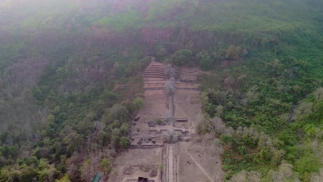 Majestic-Vat-Phou,-Khmer-temple-in-misty-hillside-jungle-drone-fly-over