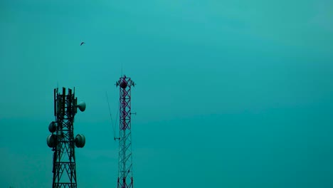 Telecommunication-network-tower-on-gloomy-monsoon-weather-against-blue-sky-background