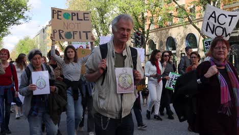 Old-and-young-protesters-at-climate-march-in-Stockholm,-close-slomo