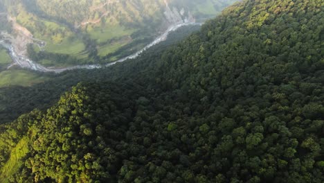 FPV-rapid-descent-over-a-mountain-with-a-river-and-valley-between-mountain-ranges