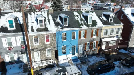 Aerial-approaching-flight-towards-colorful-row-of-houses-in-american-suburb