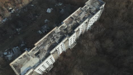 A-Drone's-Journey-Above-the-Scarred-Landscape-of-Eastern-Ukraine,-Capturing-Abandoned-Ruined-Block-of-Flats