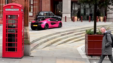 A-Pink-McLaren-and-Red-Telephone-Box-outside-of-St-Pancreas-Renaissance-Hotel,-London,-United-Kingdom