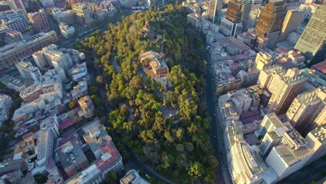 Scenic-Aerial-Drone-Flyover-Historic-Green-Santa-Lucia-Hill,-Santiago-Chile-Chiloe-4K