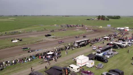 Aerial-view-of-old-cars-racing-on-dirt-track,-Friesland,-Netherlands