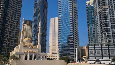 Dubai,-Emirates,-Mosque-Under-Modern-Skyscrapers-and-Residential-Towers-Panorama