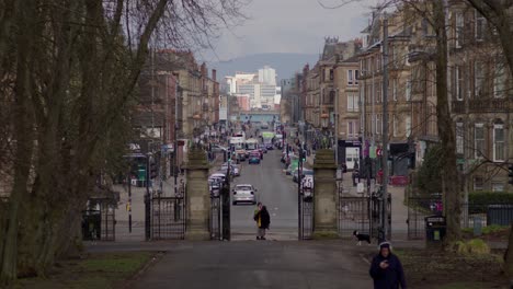 People-walking-and-talking-at-the-entrance-of-Queens-park---South-Side-of-Glasgow