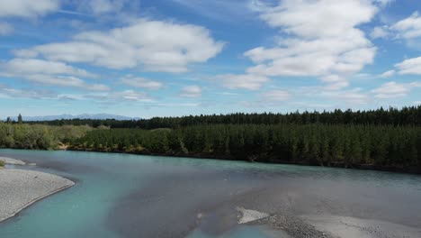 Flying-low-upstream-above-beautiful-turquoise-colored-Waimakariri-River-in-summertime---Canterbury,-New-Zealand