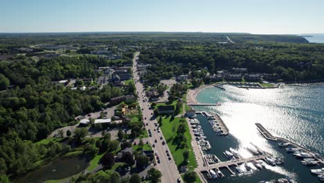 drone-aerial-view-of-main-street-in-sister-bay,-Wisconsin-on-a-sunny-day