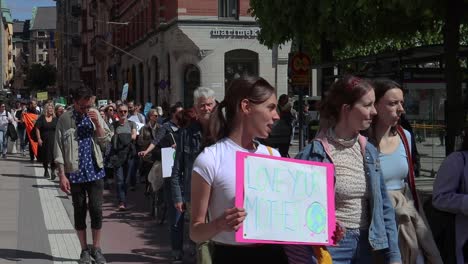 Girl-with-Love-You-Mother-Earth-sign-at-climate-protest-march,-slo-mo