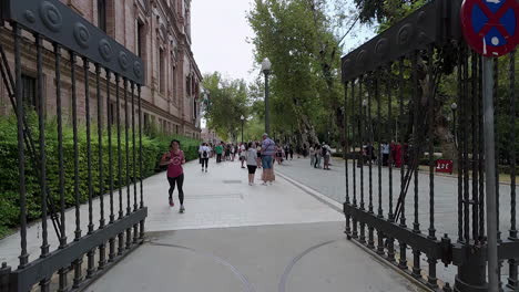 Plaza-de-España-Entrance-Gates-with-Tourists-Gathering-in-Seville,-Spain