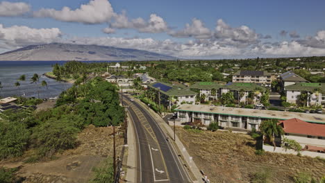 Kihei-Maui-Hawaii-Aerial-v10-drone-fly-along-the-coastal-road-from-Cove-beach-park-towards-Kalama-park,-capturing-island-town-center-and-Mauna-Kahalawai-views---Shot-with-Mavic-3-Cine---December-2022