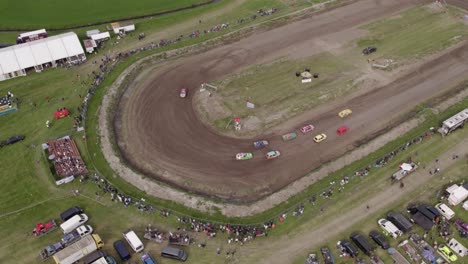 Aerial-view-of-old-cars-racing-on-dirt-track,-Friesland,-Netherlands