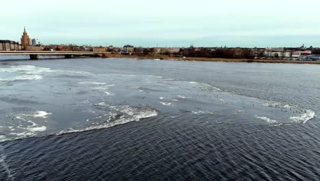 A-frozen-river-with-a-bridge-in-the-background