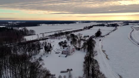 A-tall,-white-castle-standing-in-a-snowy-field