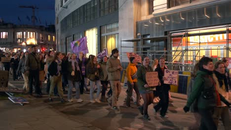 Protesters-march-for-women's-rights-and-Palestine-at-dusk