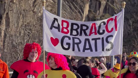 Hand-held-footage-of-a-abbracci-gratis-sign-at-the-45th-Leiferer-Fasching---Carnevale-di-Laives-carnival-parade-in-Leifers---Laives