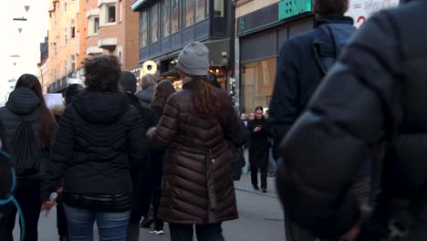 Protesters-march-against-Covid-vaccine-regulations,-close-rear-view