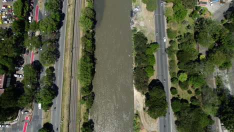 Top-Down-Aerial-View,-Street-Traffic-by-Medellin-River-Colombia