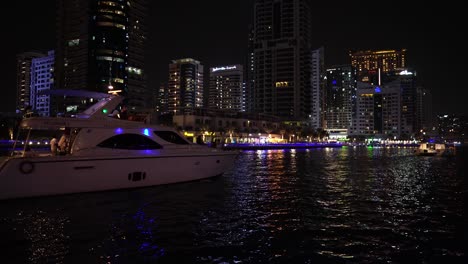 Yacht-in-Waterway-of-Dubai-Marina-at-Night,-Lights-and-Waterfront