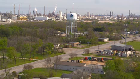 Ascending-drone-shot-of-chemical-refinery-and-surrounding-area-in-Baytown,-Texas