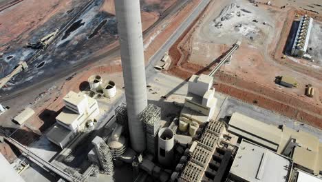 A-drone-shot-of-the-“Navajo-Generating-Station”,-a-massive-coal-fired-power-plant-and-industrial-complex-with-tall-stacks,-in-the-middle-of-the-desert-of-the-Navajo-Nation,-located-near-Page,-Arizona