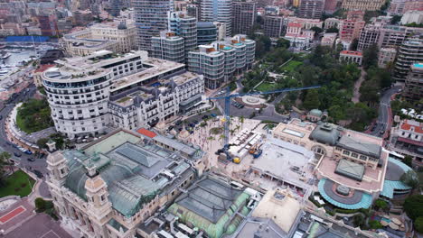 Aerial-View-of-Monte-Carlo-Casino-Building-and-Plaza-Under-Reconstruction,-City-Landmarks-and-Tourists,-Drone-Shot