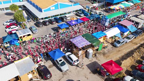 Carnaval-Grand-March-with-vibrant-red-costumes-along-streets-of-Curacao