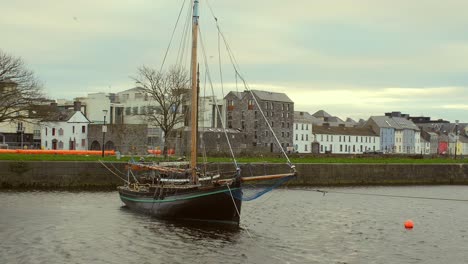 Gimbal-shot-of-a-Galway-hooker-moored-in-Claddagh,-Galway
