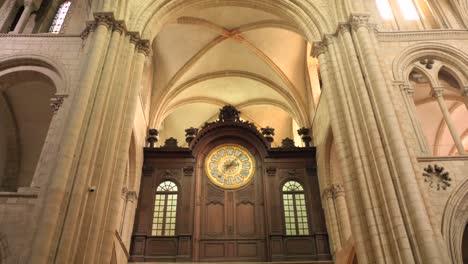 Low-angle-shot-of-a-a-large-clock-inside-the-Abbey-of-Saint-Étienne-Abbaye-aux-Hommes,-Caen,-France