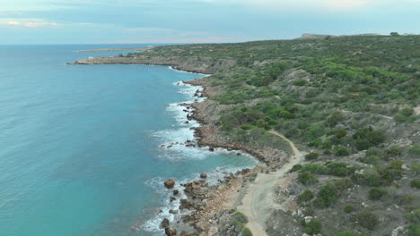 Rocky-coastline-near-Konnos-Beach,-Ayia-Napa,-Cyprus,-with-clear-blue-waters
