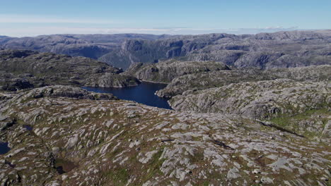 Aerial-shot,-panning-across-the-rocky,-mossy-landscape-of-Rogaland,-Norway