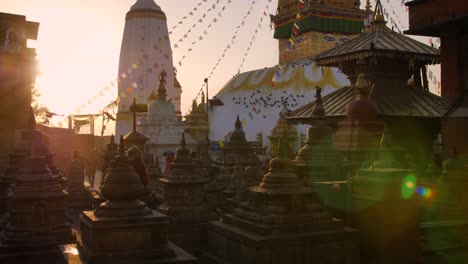 Morning-prayers-at-the-main-Stupa-and-statues-at-the-Monkey-Temple-at-sunrise,-Kathmandu,-Nepal