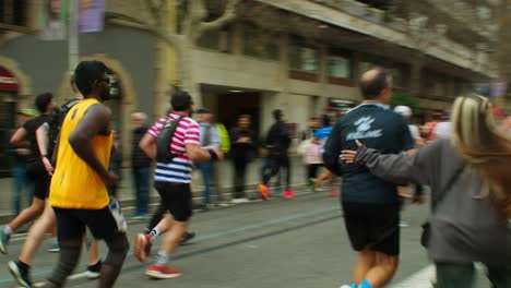 Barcelona-Marathon-Happy-Runner-Quick-Stop-Greeting-Friends-Family-near-Sagrada-Familia-with-Joyful-Cheers