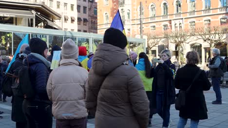 Women-with-Ukrainian-flags-at-rally-against-Russian-invasion,-static