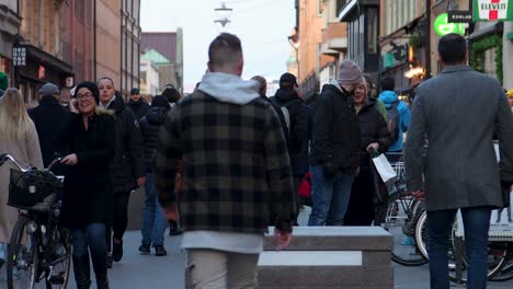 People-walking-and-moving-on-bikes-and-scooters-in-city,-static-slomo