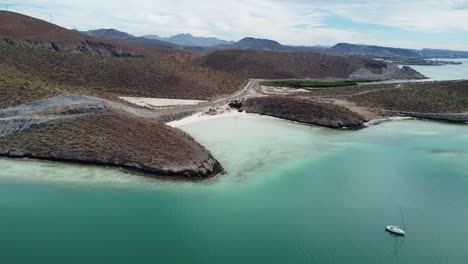 Playa-balandra's-clear-turquoise-waters-and-sandy-isthmus,-baja-california,-mexico,-aerial-view