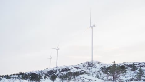 Wind-Turbines-Against-Cloudy-Sky-In-Bessaker,-Norway-In-Winter---Wide-Shot