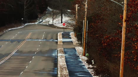American-empty-street-on-a-frozen-icy-day,-telephoto,-lowering-shot,-USA