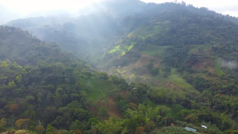 Sun-Rays-Through-Mist-Over-Tropical-Rolling-Hillside-In-Risaralda,-Colombia