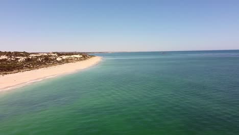 Aerial-flyover-calm-turquoise-waters-of-Mindarie-beach,-Perth-australia