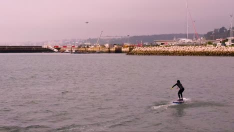 Surfer-on-the-water-near-a-marina-practice-the-overboard