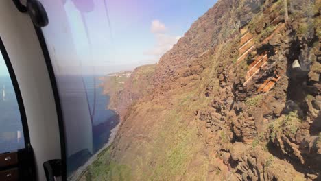 Pov-of-steep-Cable-car-ride-in-Fajã-dos-Padres,-Madeira-Island