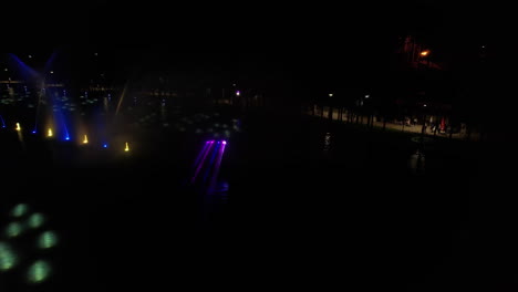 Stunning-Light-and-Animation-Projection-on-Fountains-at-Lake-in-Zlatibor-Mountain-Resort,-Serbia,-Aerial-View
